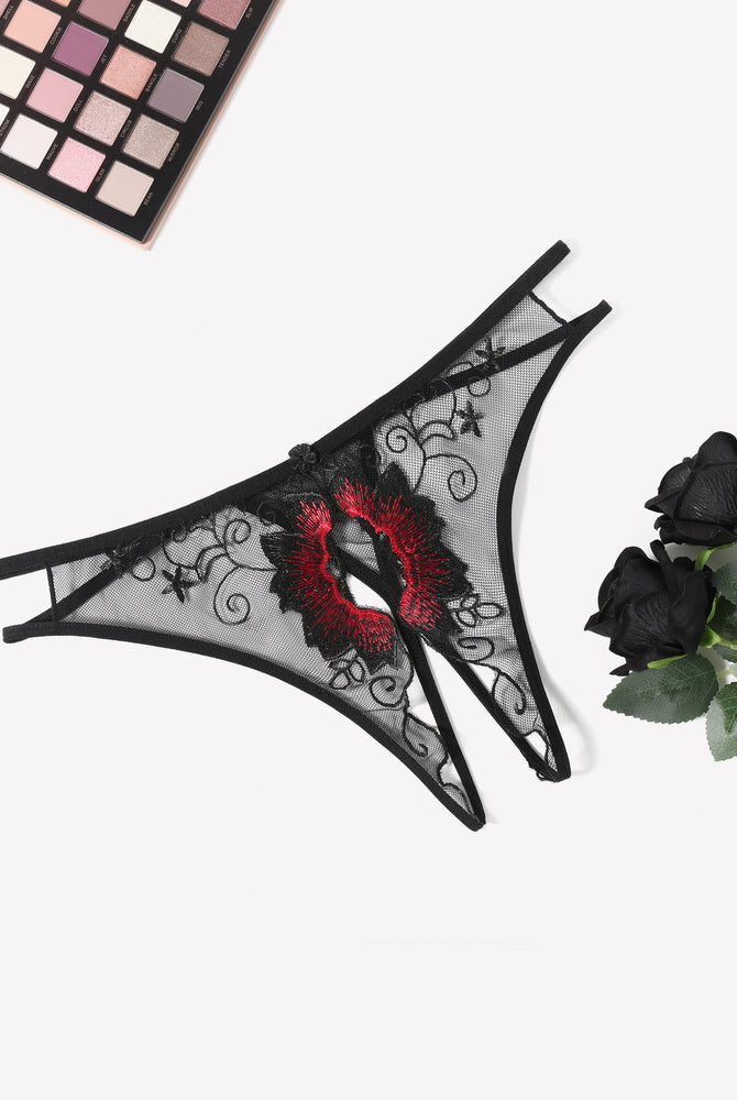 Black mesh thong panty with red floral embroidery, scalloped lace trim, and thin ties.