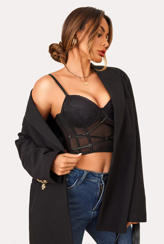 Black lace corset top with mesh design, black blazer, and blue jeans. Sexy lingerie.