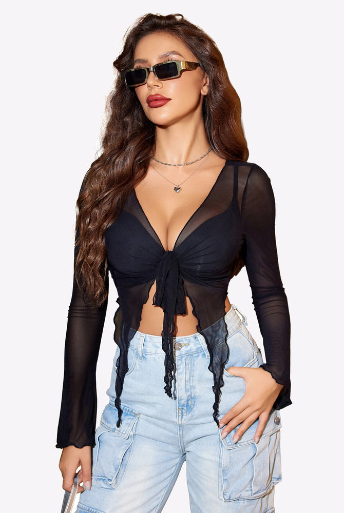 Black mesh tie front crop top with long sleeves, Y2K style, paired with cargo pants.