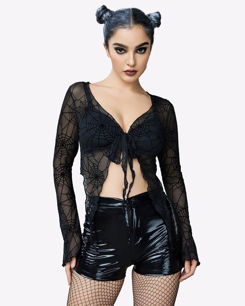 Y2K spiderweb mesh crop top, tie front, black shorts. Long sleeve lingerie.