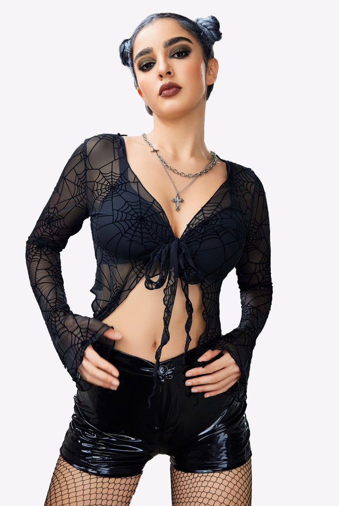 Black spiderweb mesh crop top with tie front, Y2K style, black shorts, long sleeves. Sexy lingerie.
