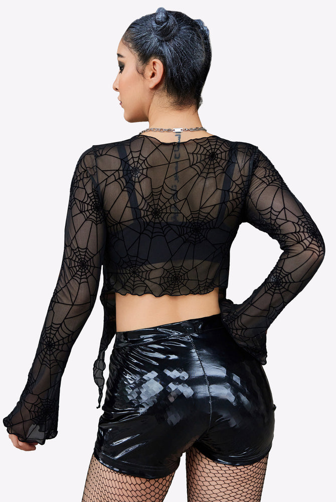 Black spiderweb mesh crop top with tie front, Y2K style, shiny black shorts. Sexy lingerie.