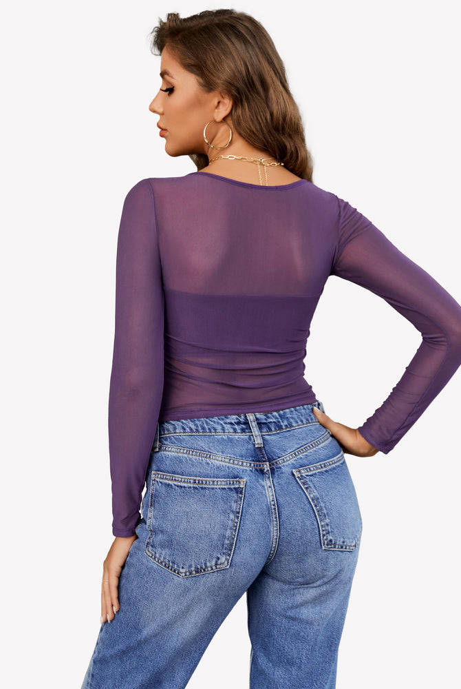 Avidlove purple mesh asymmetrical crop top with long sleeves and blue jeans. Stylish sheer top.