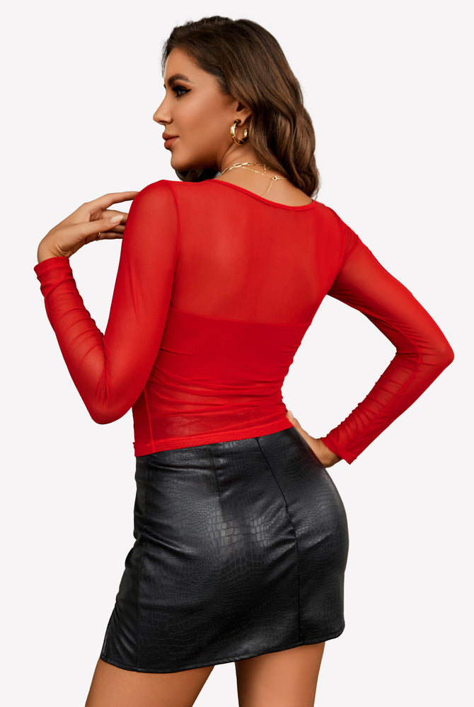 Red mesh asymmetrical crop top with black mini skirt. Sensual, sheer top.