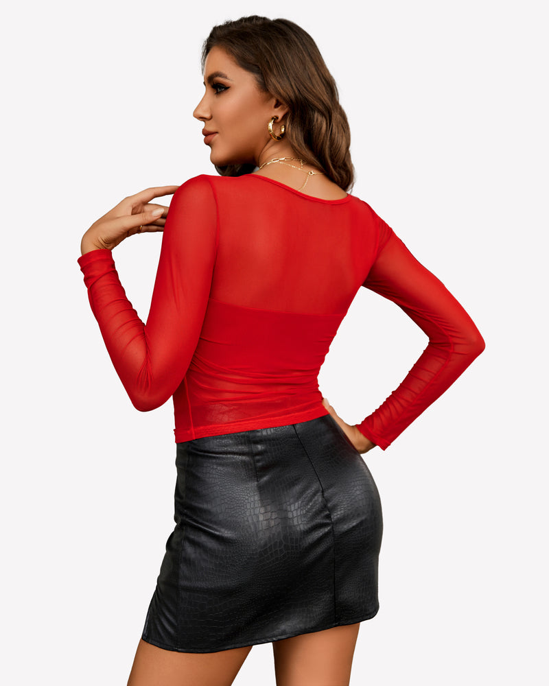 Red mesh asymmetrical crop top with black mini skirt. Sensual, sheer top.