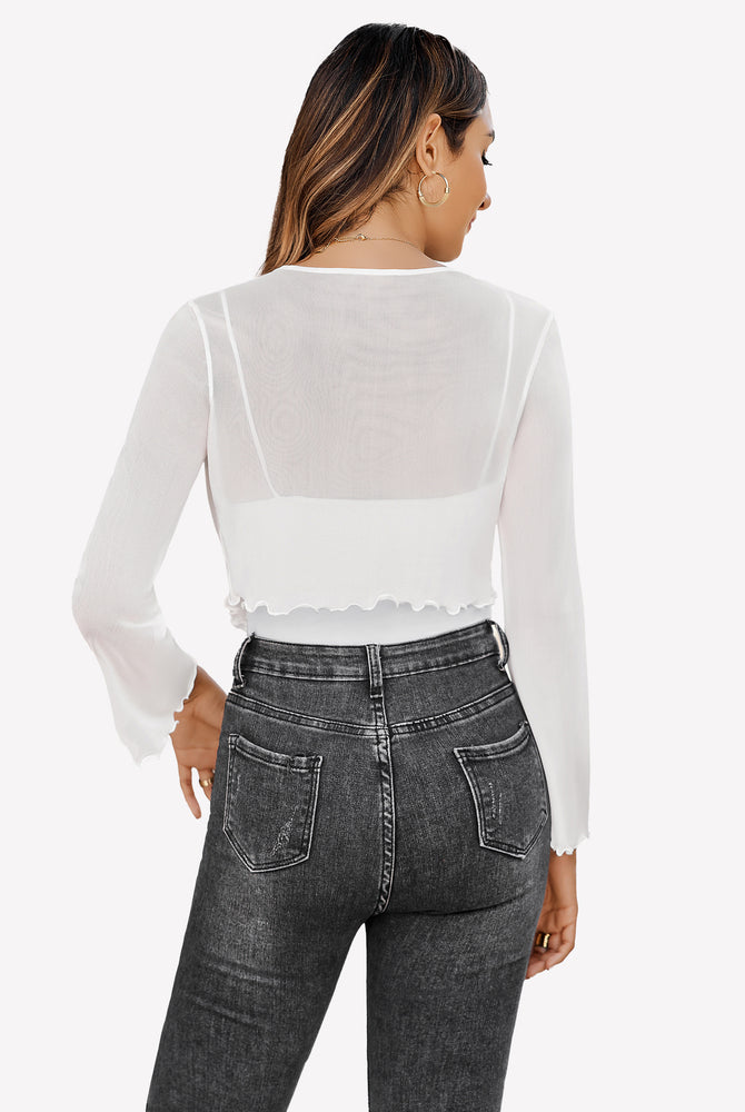 White sheer mesh shrug with bell sleeves, paired with jeans, a versatile top.