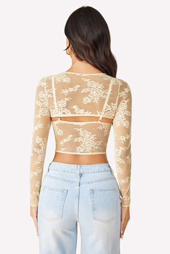 Beige lace long sleeve cami top with floral design and light blue jeans. Sexy lingerie.