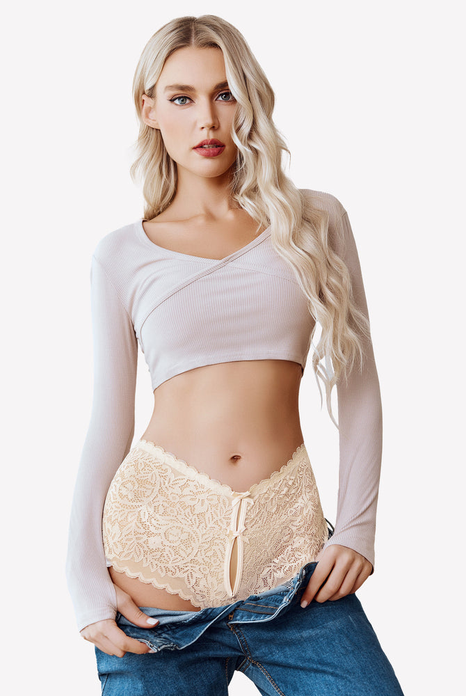 Beige lace boy shorts with bow accent, mid-waist panties, no-line look, worn by a woman in jeans