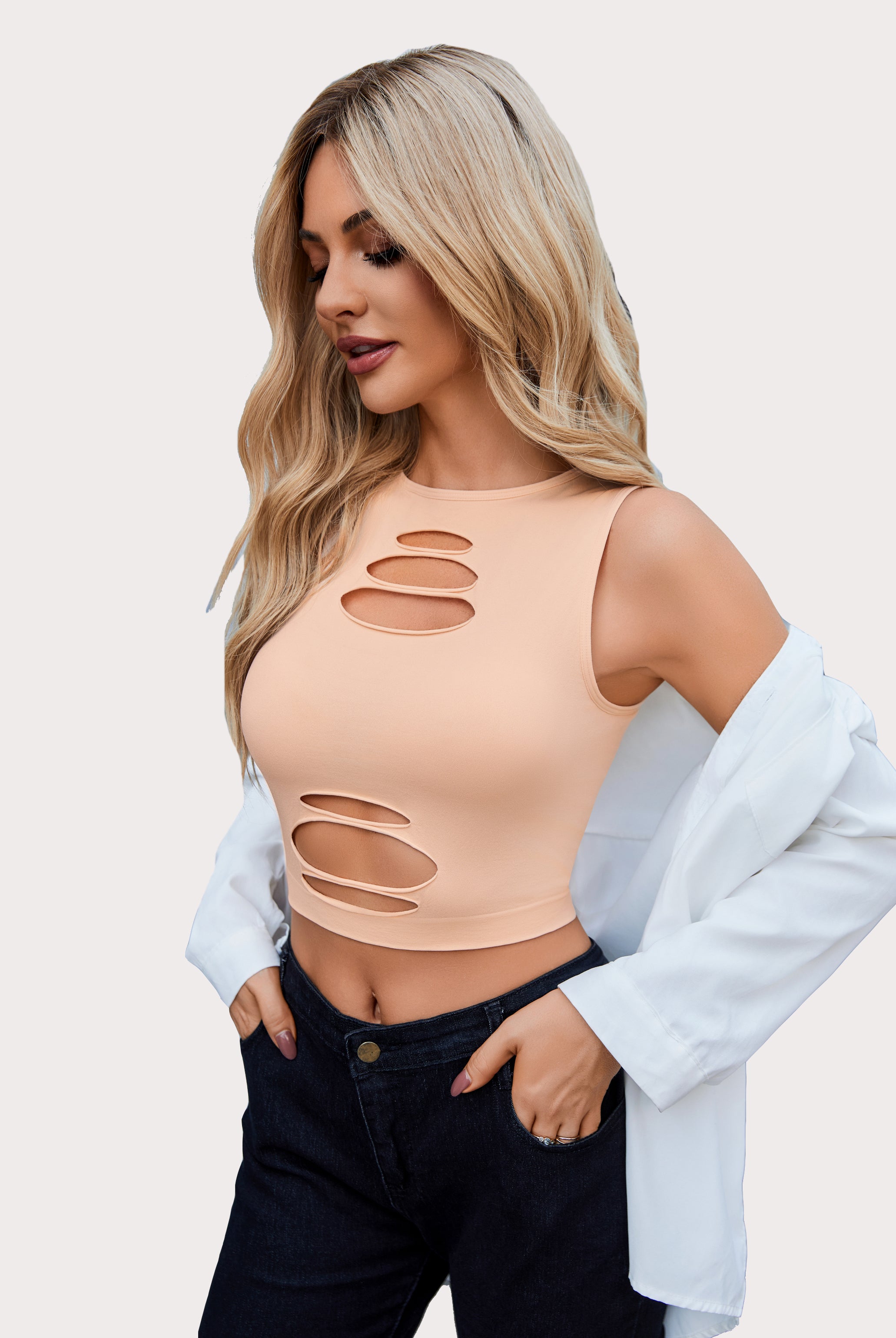 Peach cut-out crop tank top and dark denim jeans, fashionable for women, showing curves.