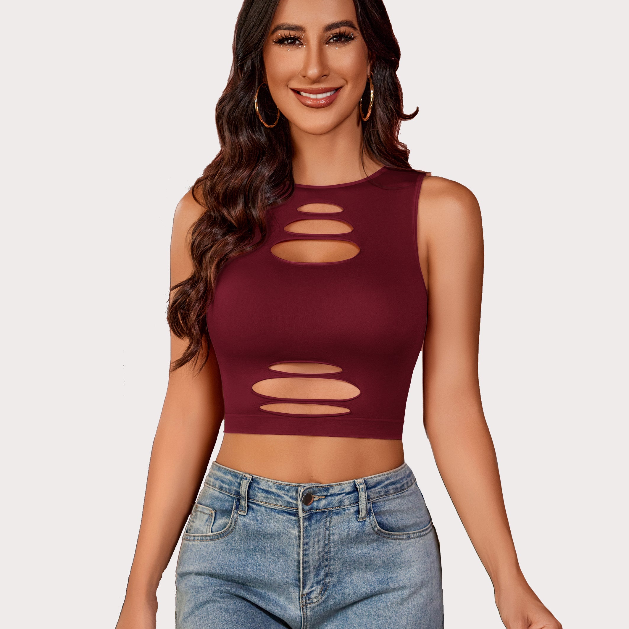 Burgundy cut-out crop top and denim jeans, fashionable, showing curves. Fishnet crop top