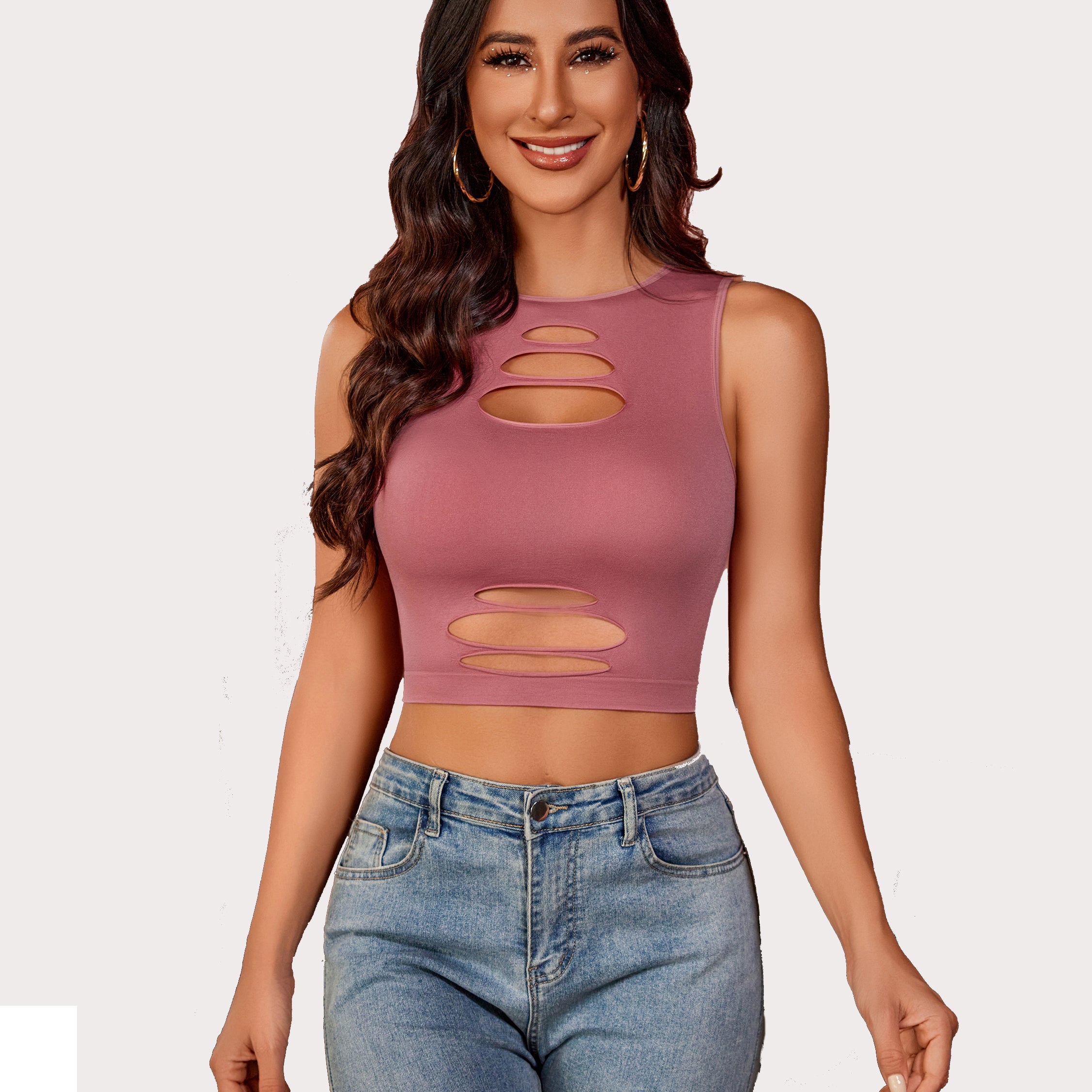 Dusty rose cut-out crop tank top with light denim jeans, showing an attractive curve for women.