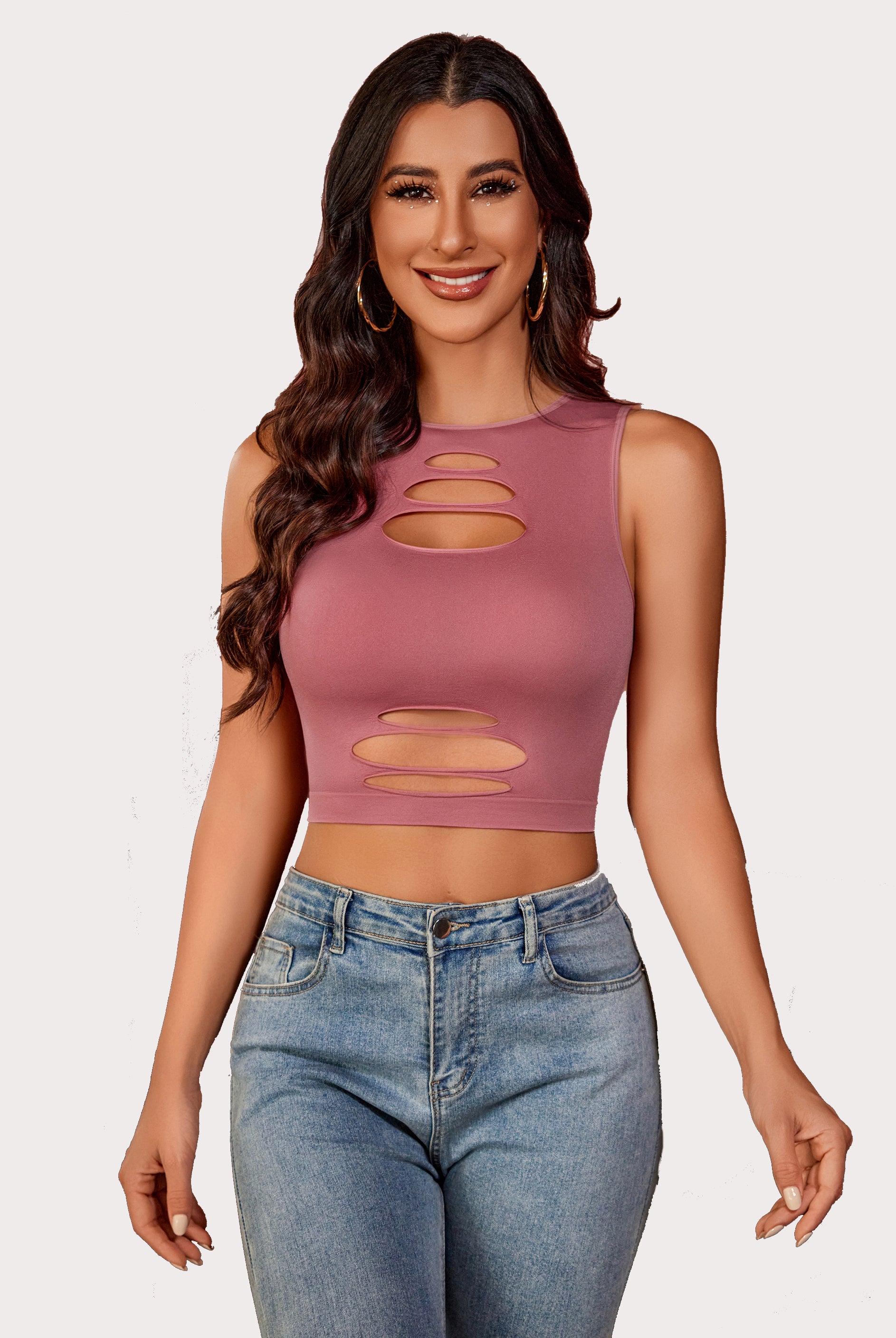 Dusty rose cut-out crop tank top with light denim jeans, showing an attractive curve for women.