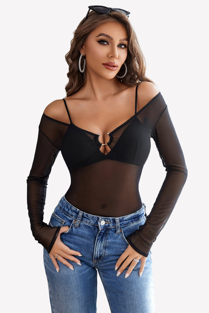 Black mesh long sleeve blouse top with off-shoulder design and ring detail, paired with blue jeans.
