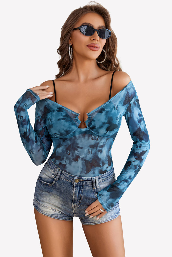 Blue butterfly mesh off-shoulder blouse with ring detail and denim shorts; sexy and stylish.