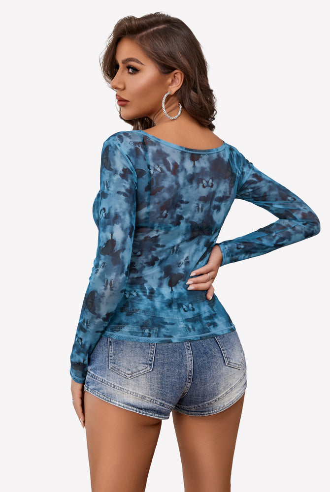 Blue butterfly mesh blouse with denim shorts; sexy and stylish, perfect for a confident look.