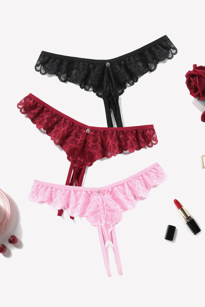 Criss-cross lace thong briefs in black, burgundy, and pink with ruffle trim