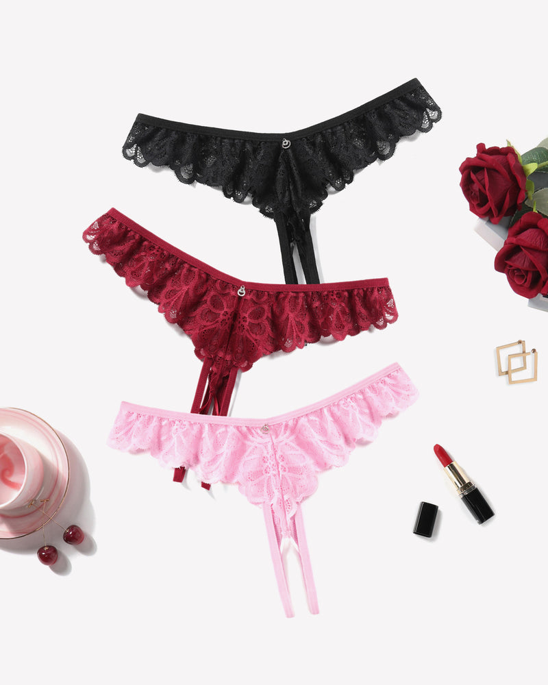 Criss-cross lace thong briefs in black, burgundy, and pink with ruffle trim