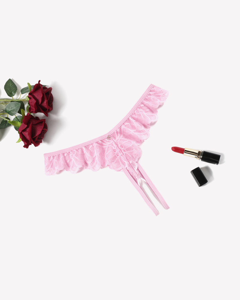 Pink lace thong briefs with criss-cross design, ruffle trim, and lipstick