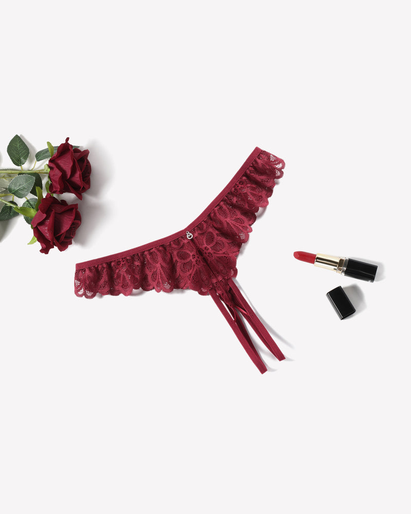 Burgundy lace thong briefs with criss-cross design, ruffle trim, and rhinestone embellishment