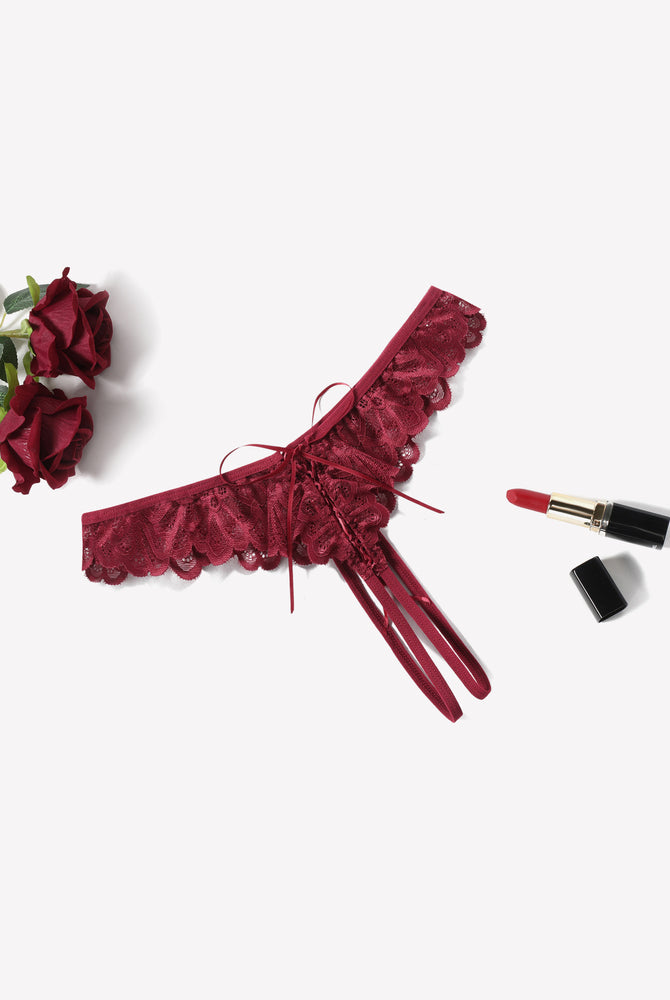 Burgundy lace thong briefs with criss-cross design, ruffle trim, and lipstick