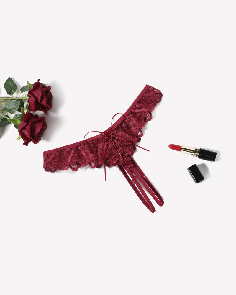 Burgundy lace thong briefs with criss-cross design, ruffle trim, and lipstick