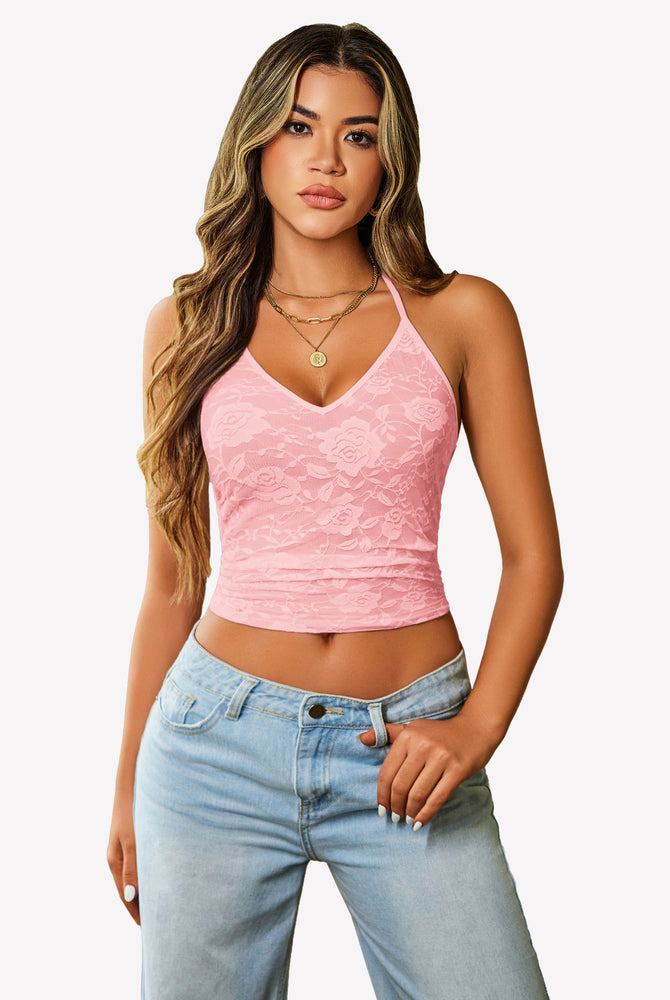 Pink lace halter crop top with adjustable straps, paired with light wash jeans. Y2k style.