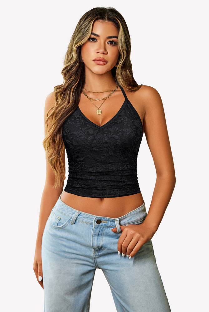 Black lace camisole halter crop top with adjustable straps, paired with jeans. Y2k style.