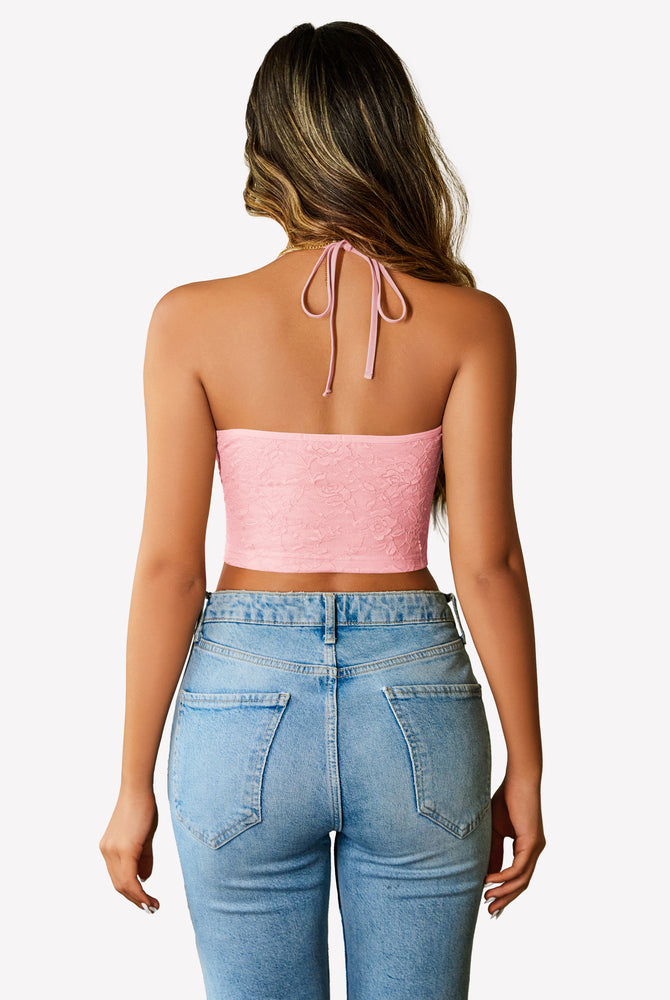 Pink lace halter crop top with adjustable straps and light wash jeans. Y2k style lingerie.