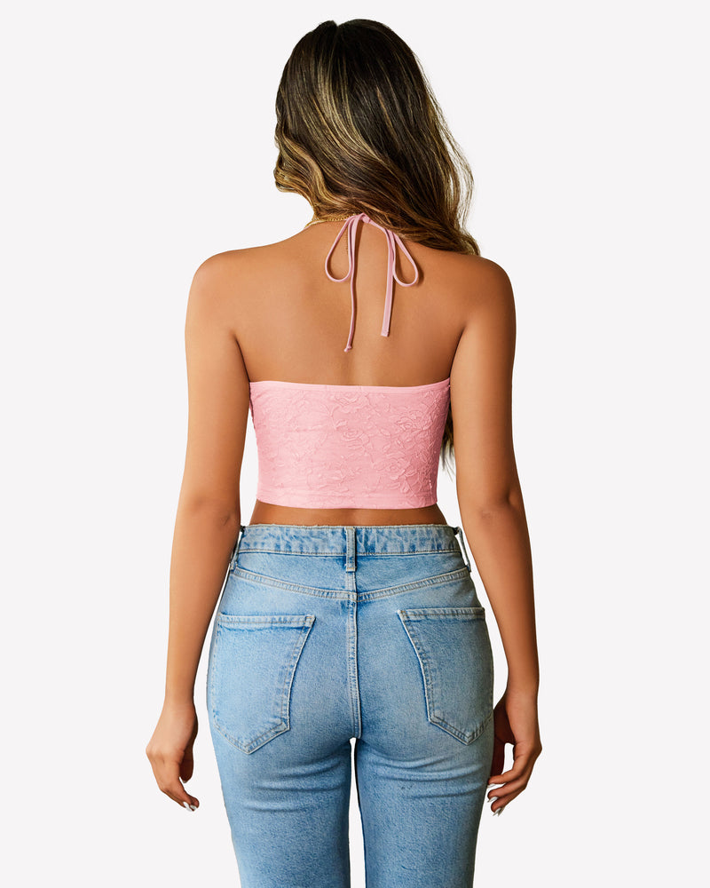 Pink lace halter crop top with adjustable straps and light wash jeans. Y2k style lingerie.