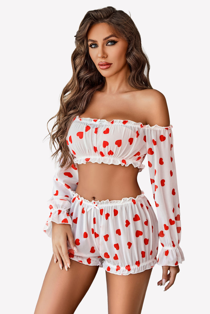 White off-shoulder lingerie set with red heart print, long sleeves, and ruffle trim