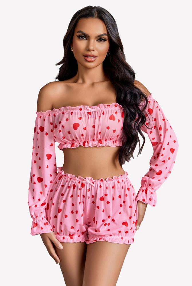 Pink heart-print off-shoulder lingerie set. Ruffle trim, long sleeves, and bow detail.