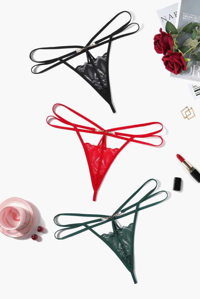 Floral lace thong briefs in black, red, and green with strappy design and gold accents