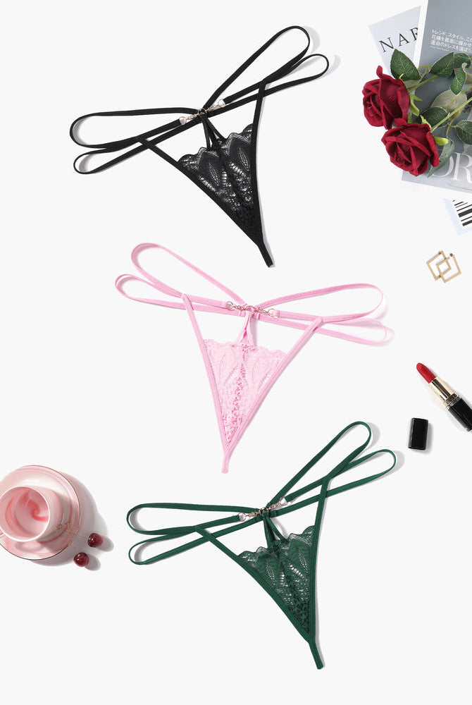 Floral lace thong briefs in black, pink, and green with strappy design and gold accents
