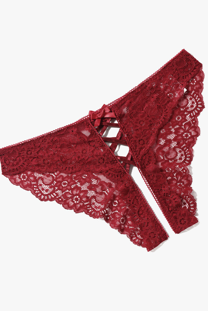 Red lace hipster panties with criss-cross straps and bow detail. Floral lace design.