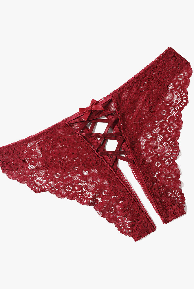 Burgundy lace hipster panties with criss-cross straps and bow detail. Delicate floral lace design.