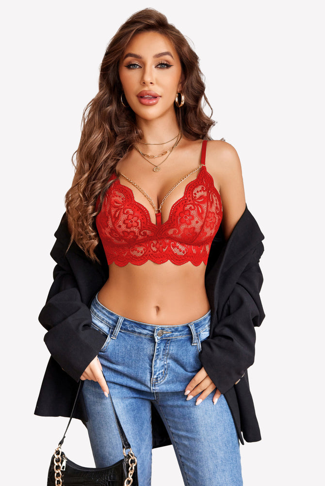 Red lace bra with chain details, part of a lingerie set. Confident and stylish look.