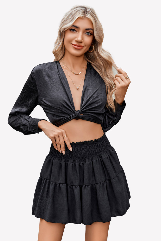 Black flowy A-line short skirt with tiered ruffles and elastic smocked waistband