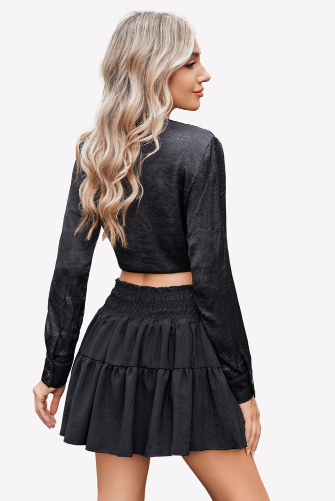 Black flowy A-line short skirt with tiered ruffles and elastic smocked waistband