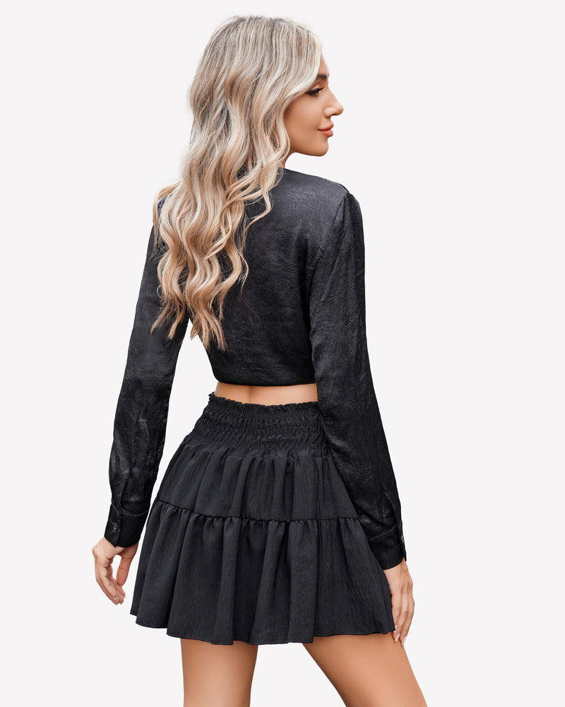 Black A-line short skirt with shirred waist, paired with a black crop top, flattering curve