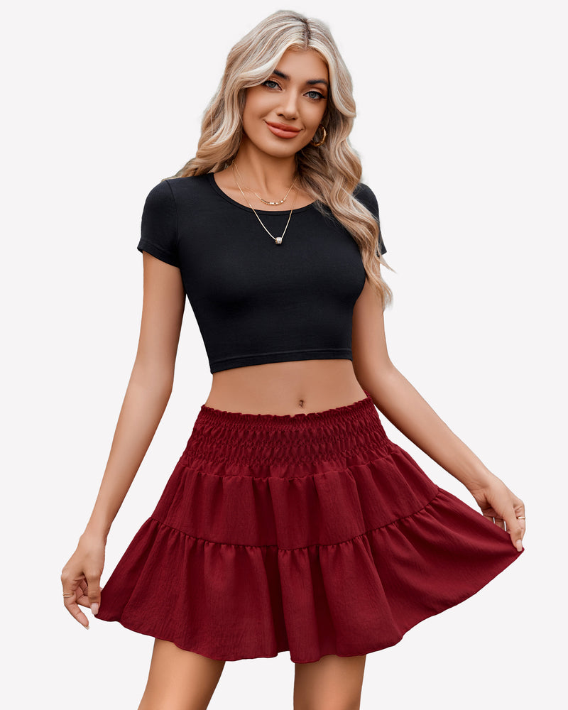 Burgundy flowy A-line short skirt with shirred waist, paired with black crop top, flattering curve