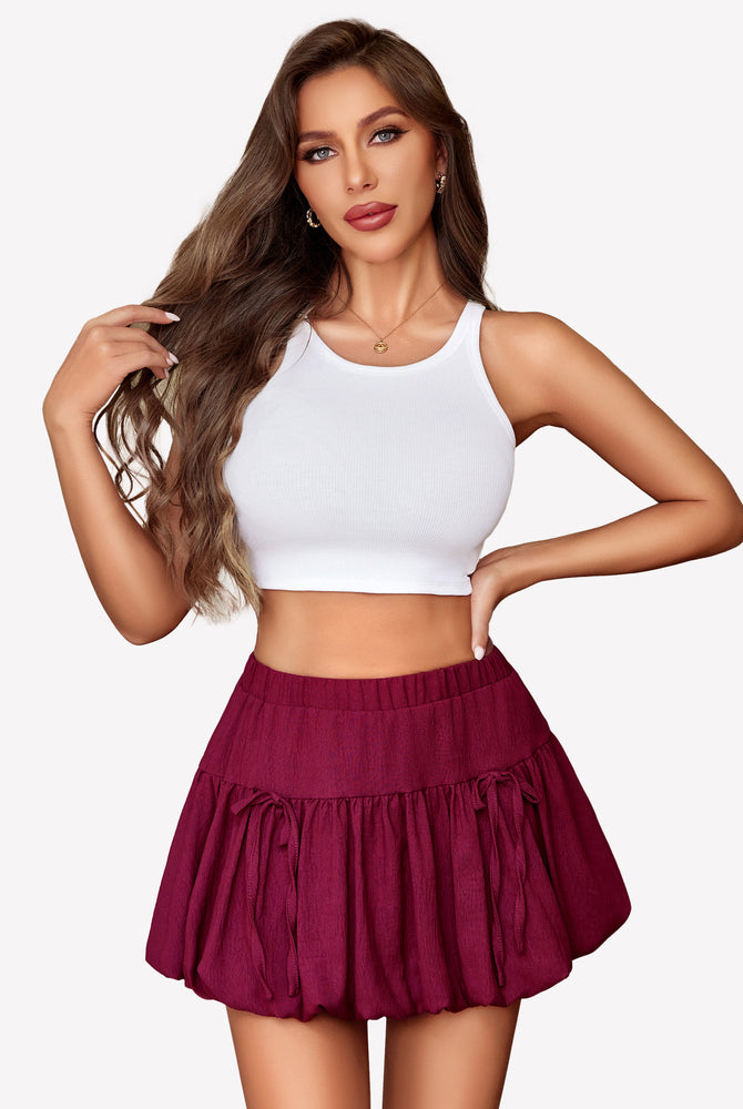 Burgundy bubble hem mini skirt, Y2K style, with tie details, paired with a white crop top