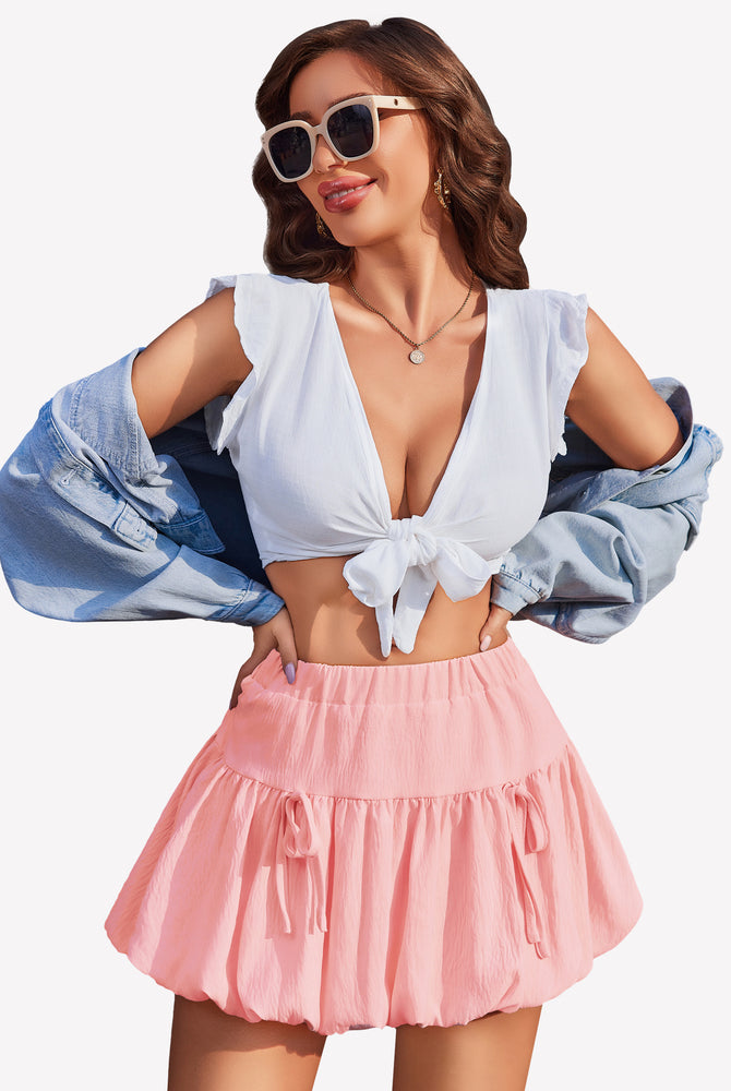Pink bubble hem mini skirt with tie details, white crop top, Y2K style, perfect for parties