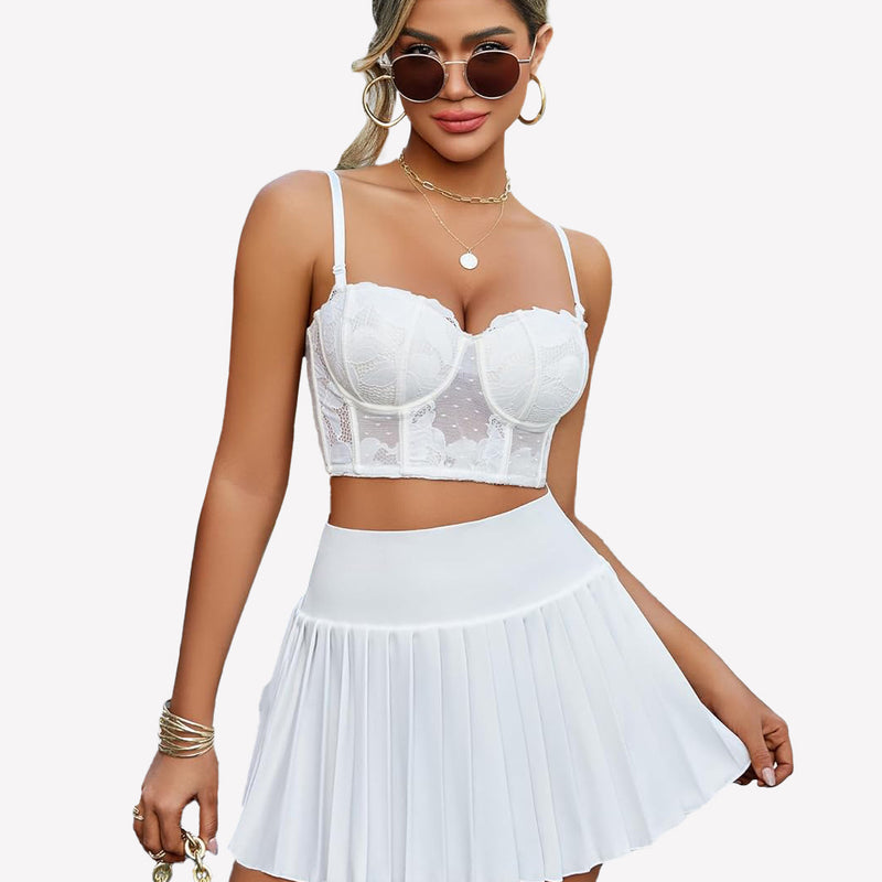 White Y2k pleated mini skirt and lace crop top. High-waisted design for confident style.
