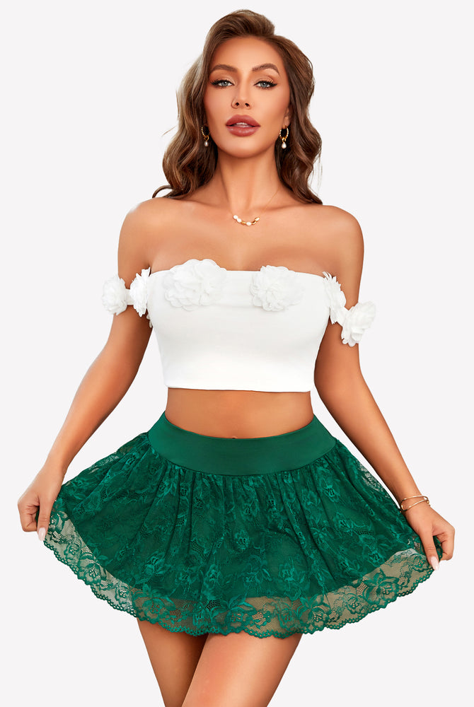 Green lace mini skirt with ruffle hem, paired with a white crop top, perfect for a flattering look.