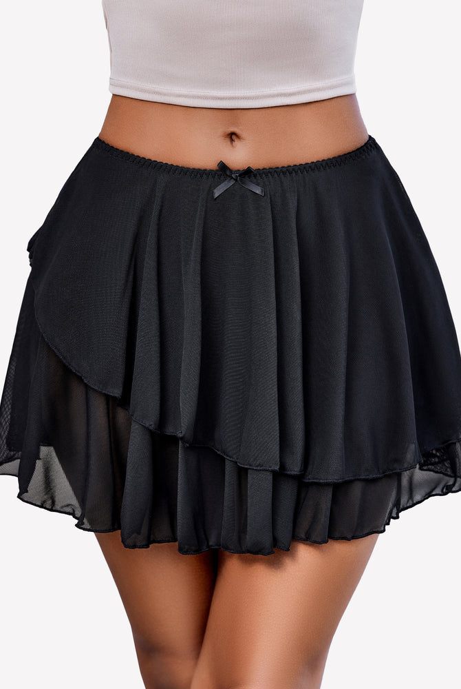 Y2k black pleated mini skirt with asymmetrical design and bow detail. Flowy and stylish.