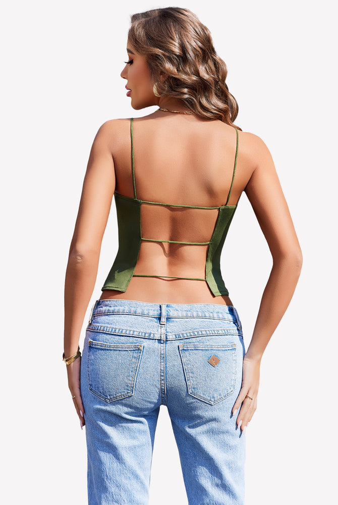 Green backless cropped top with thin straps and light blue jeans, perfect for summer.