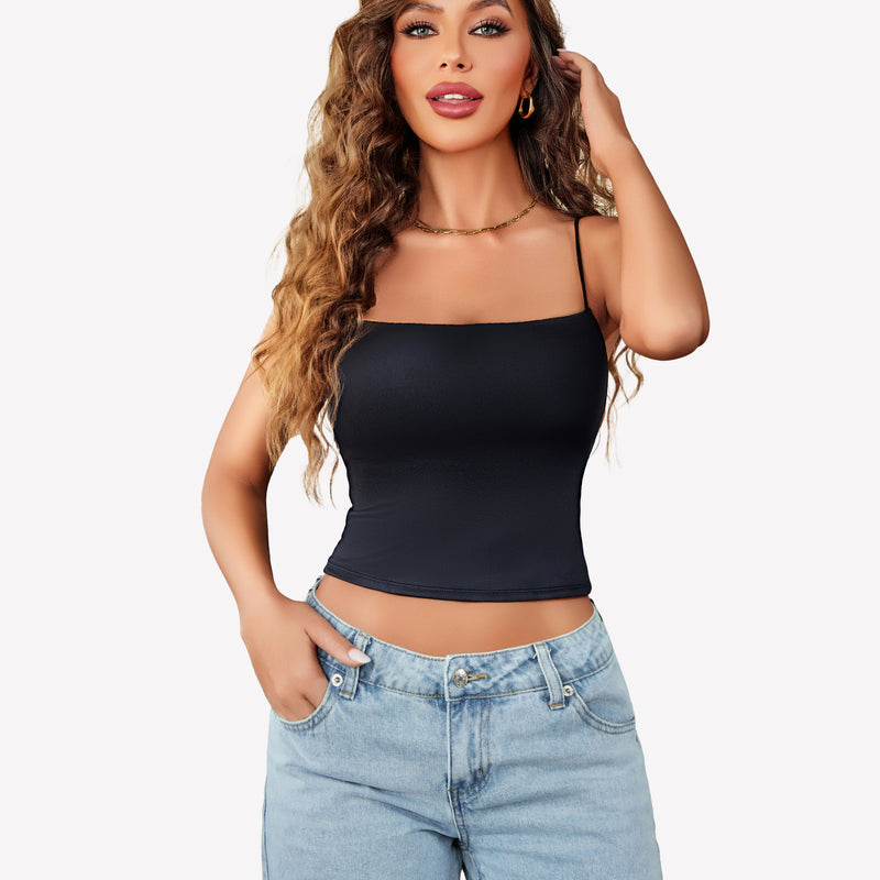Black cropped top with thin straps, backless design, paired with light blue jeans