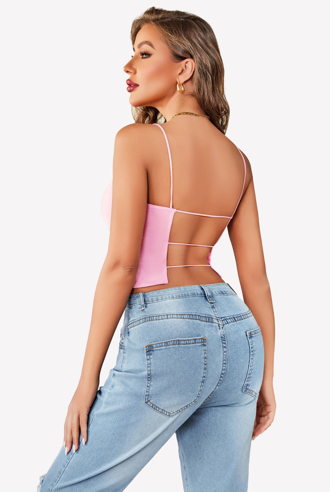 Pink backless cropped top with thin straps and light blue jeans, summer outfit