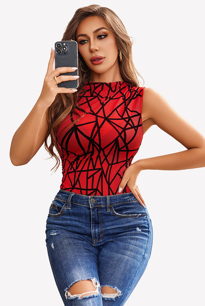Red geometric mesh bodysuit, sleeveless, mock neck, ruched, paired with jeans. Clubwear.