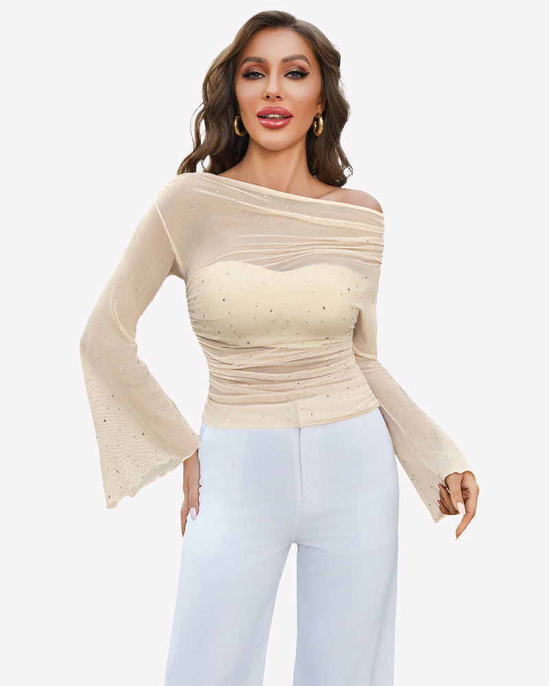 Beige mesh off-shoulder top with rhinestone accents, long bell sleeves, and white pants